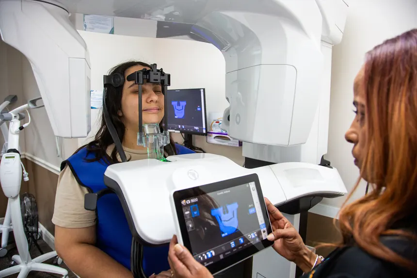 A patient at the 3D CT scanner reviewing her digital scan on a tablet